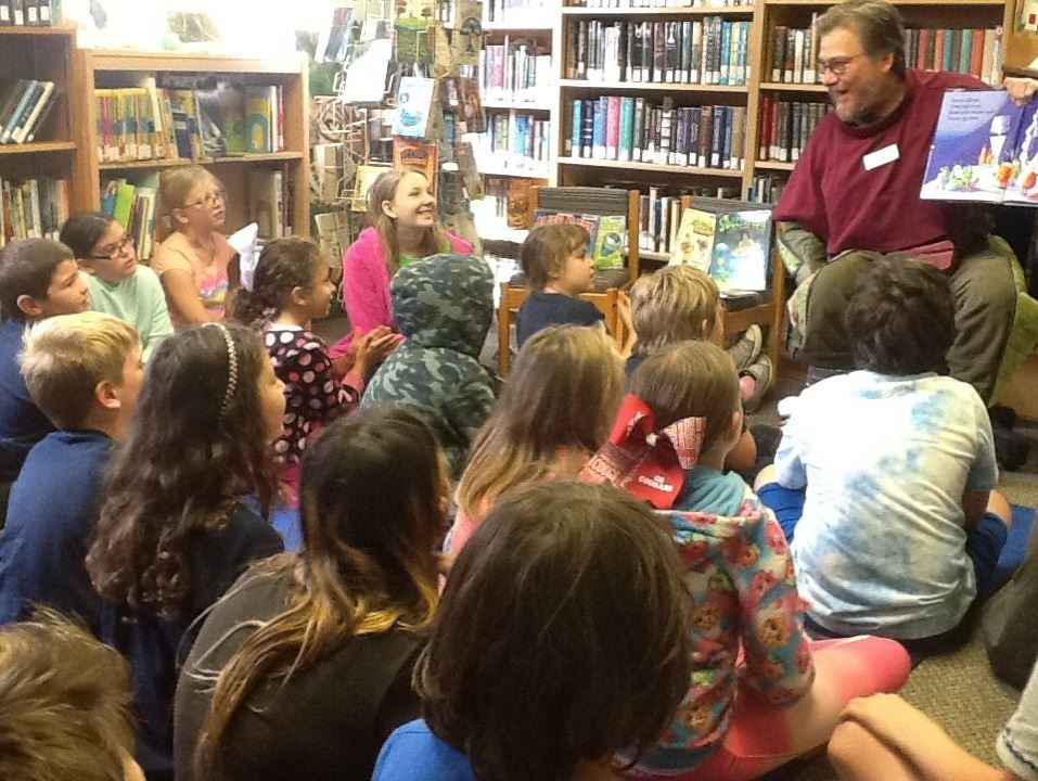 Captain Cosmos reading to the kids